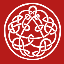 A knotwork, a design often associated with Celtic knots. The outer design is a circle, surrounding what appears to be a triangle surrounded by a Celtic knot at first glance. Closer inspection of the triangle reveals that it is in fact an organic part of the inner knot, which seems to have two continuous segments linked by knots. At first glance, the knotwork appears to be symmetric; closer inspection reveals that the right-hand knots seem to be the reverse of the left-hand knots and there are small differences among the "twin knots"; the right and left hands of the design have variations, much as our right and left hands have subtle distinctions. The design is not symmetric with respect to 120 degree rotations: The center of the pseudo-triangle is above the center of the surrounding circle, but visual balance is maintained by extra knots below the lower pseudo–line-segment. The background is crimson.