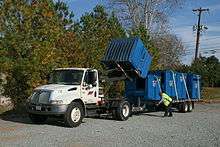 An International DuraStar used to transport Dumpsters.