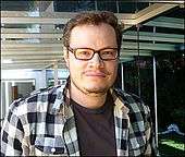 A Caucasian man with reading glasses.