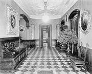 Entrance hall of Davies House with black walnut trim and carved plaster