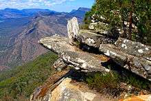 and the opposing view into Victoria Valley from the Balconies with several thin rock slabs lying atop one another on a ledge