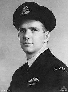 A slightly side on head and shoulders portrait of a man in formal military uniform. He is wearing a cap.