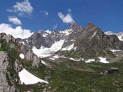 Mountain with glacier and mountain hut below