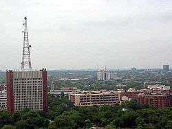 Distant photo of building complex with tower