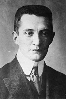 Head and shoulders black-and-white photograph of a clean-shaven Kerensky in his late-thirties/early-forties with dark eyes and hair