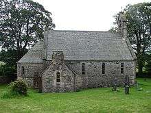 A small church with an apse and a bellcote