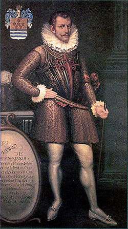 Painting of a bearded man in early 16th-century attire including prominent ruff collar, wearing a decorative breastplate, with his right hand resting on his hip and his left hand grasping a cane or riding crop.