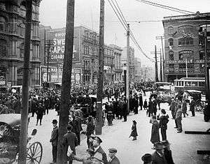 Masses of people on big-city street.