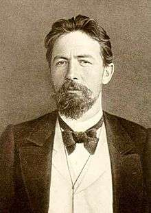 Chekhov seated at a desk