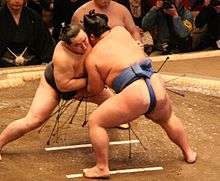 A sumo match (tori-kumi) between former yokozuna Asashōryū (left) and then-komusubi Kotoshōgiku in January 2008.