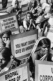 Number of women pictured in black and white colour, sitting and protesting against Anderson and the company.