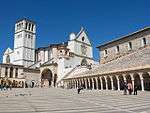 A white church with a white tower next to it.