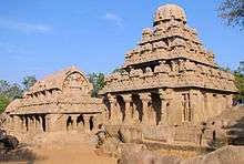 Ruins of a sandstone building with columns.