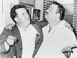 Gleason standing with Irish author Brendan Behan, arms around each other