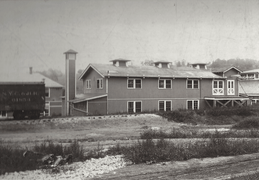 Long, two-story building next to a railroad