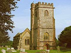 Stone building with prominent square tower.