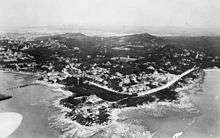 View of a coastal city from a high-altitude point at sea