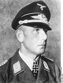 A man wearing a military uniform with an Iron Cross displayed at the front of his uniform collar.