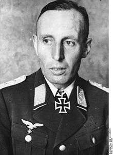 A man wearing a military uniform with an Iron Cross displayed at the front of his uniform collar.