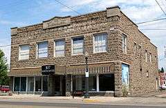 Photograph of a 2-story, stone-faced commercial building