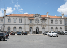 Railway station. Two-story white building with terra-cotta roof. "Caldas da Rainha" written atop center of façade.