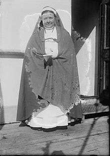 Woman singing in a cassock