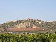 Large hill topped with castle walls