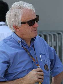 Man in his late fifties wearing sunglasses and a blue T-shirt