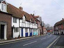 a narrow road flanked by small houses