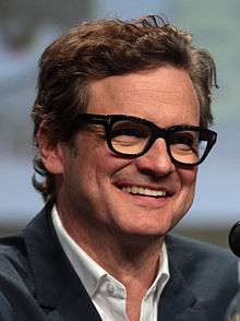 A close up portrait of a middle aged man in a dinner jacket entering a film event