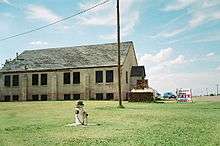 A large church with a decaying roof sits nearly alone in a small town in southwestern Oklahoma.