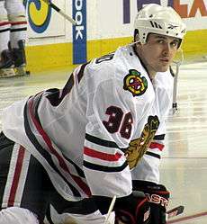 Hockey player warms up prior to a game as he intensely looks at the camera