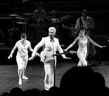 Dancers striking a pose with their arms stretched to their sides