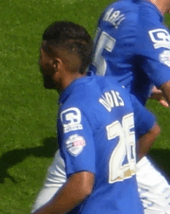 Dark-skinned man wearing blue sports kit