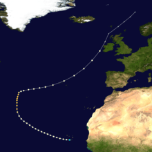 Path of a hurricane, with colored dots representing the storm's intensity at different positions in six-hour intervals. The storm begins in the lower-center of the image near a landmass, moves left, up, and then generally moves towards the upper-right corner of the image. The colored dots reflect a gradual increase and then decrease in intensity.