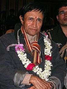 Still of a man wearing garland.