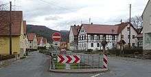 A roadway through a village.