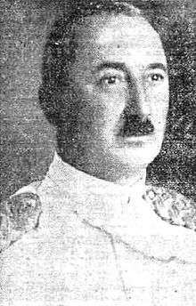 black and white portrait of a dark-haired man wearing dress uniform