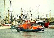 A Waveney-class lifeboat floating on its moorings.