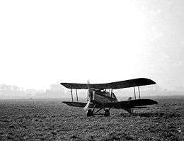 Military biplane on landing ground