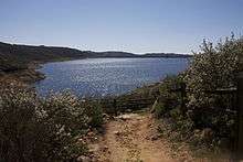 This is a photo of the Olivenhain dam & reservoir, which is located within the Elfin Forest Recreational Reserve. It is visible from part of the 11 miles of hiking that the reserve offers.