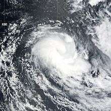 An organized area of low pressure with convection wrapping around the center