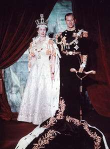 Elizabeth in crown and robes next to her husband in military uniform