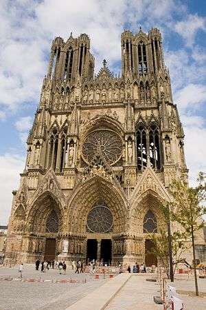 Notre-Dame de Reims façade, gothic stone cathedral against blue sky