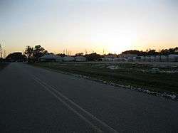 There are semi-truck-sized bales of cotton stored on this lot along Fairchilds Road.