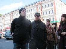 Two men and a woman on a street corner