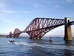 A cantilever bridge crossing a wide river.