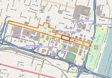 In the middle of a colored road map, a long strip of land is outlined in orange, while a small rectangle within this strip is outlined in red.