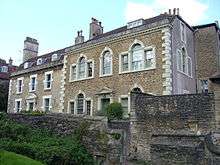 Two-storey houses behind wall