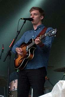 George Ezra holding a guitar